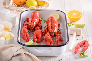 Cooked red lobster served with citrus and butter.