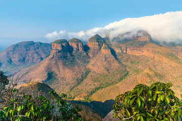 A view over bushes on the rim of Blyde River Canyon towards the three Rondavels,  Mpumalanga, South Africa in Springtime