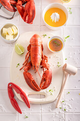 Steamed red lobster with orange butter sauce.