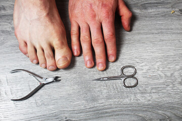 Scissors and nail clippers palm foot close-up. Selection of scissors for nail care. Close-up