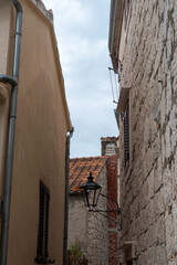 Narrow stone alley with wall lantern © Sergey