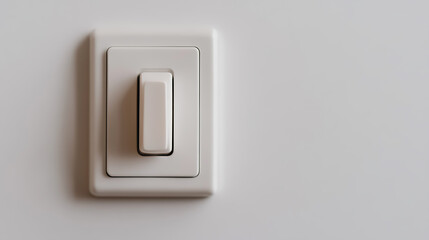 Fototapeta premium A simple white electrical switch is mounted on a matching wall, embodying minimalist design and functional technology in a residential or commercial space.