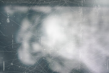 Dark textured overlay with light areas and fine surface imperfections. Subtle scratches and particle details add depth and character, suitable for use in design, photography, or digital art projects.