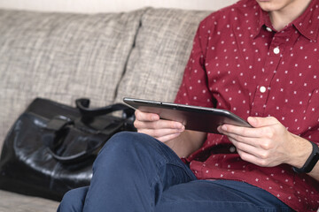 A Young Man Engaged in Using a Tablet While in a Relaxed and Casual Setting of Home