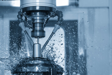 The CNC milling machine cutting the shell mold parts with oil coolant method .