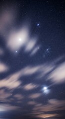 Naklejka premium Night Sky Canvas - A Dreamy Dance of Stars and Clouds.