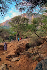View of female hiker wearing a hijab against a Mountain background in the Ndoto Mountain Range in Ngurunit in Marsabit County, Kenya 
