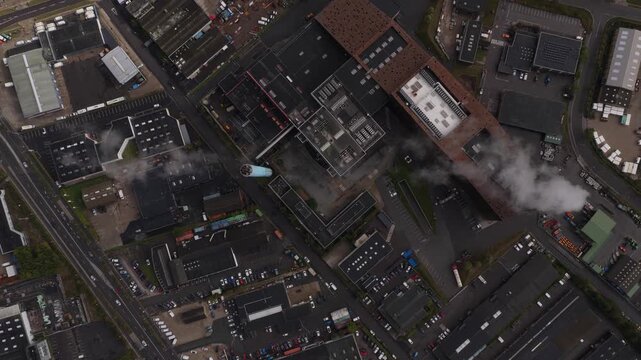 Drone view: smoke over power plant, electricity generation in action.