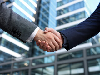 Professional business handshake in modern office building, partnership agreement and corporate success concept, businessmen shaking hands for teamwork and cooperation