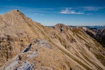 View Of The Geierkopf Main Summit During The Geierkopf Ridge Crossing In The Austrian Alps: Impressive Rocky Mountain Landscape Under Clear Blue Sky