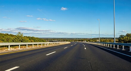 Fototapeta premium Empty highway stretches into a clear blue sky