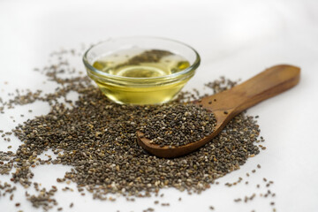 Chia oil with chia seeds on white background. Healthy food,superfood or body care concept....