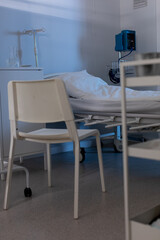 A Quiet Hospital Room with a Bed and a Chair for Patients in Need of Care and Comfort