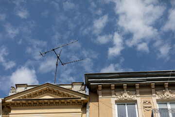 Antennas are prominently displayed on a Historic Building against a backdrop of a clear blue sky