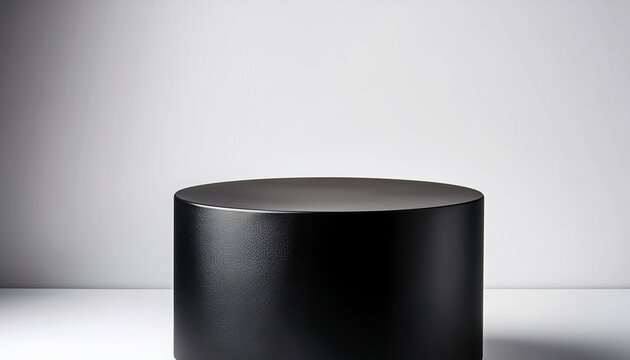 a simple black cylindrical pedestal on a minimalist white background perfect for product displays or showcasing small items