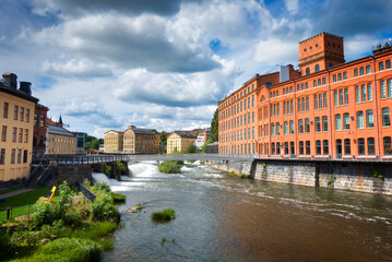 Obraz premium Old industrial area on the Motala ström river in the city centre of Norrköping, Sweden