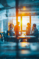 Bright sunset illuminates a team meeting in a modern office setting