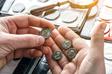 Numismatics.Authentic silver denarius, antoninianus of ancient Rome. A collector holds an old...