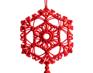 A detailed, red, woven ornament with intricate geometric patterns hanging