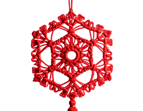 A detailed, red, woven ornament with intricate geometric patterns hanging