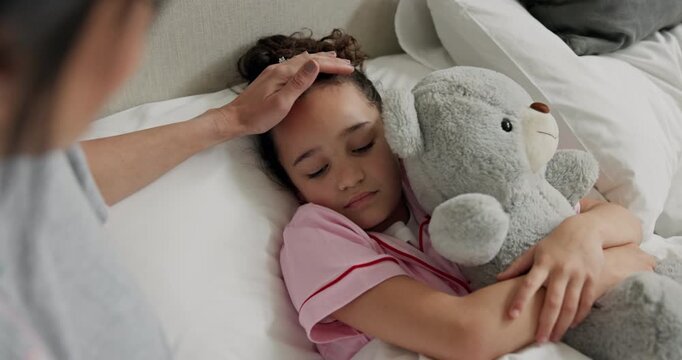 Mother, support and sick child with teddy bear in bed, monitor fever and illness symptoms of daughter. Comfort, touch forehead and woman care for girl in home, virus infection and check temperature.