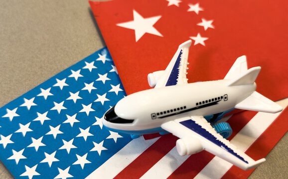 Chinese flag in front of a passenger airplane at the airport, overlaid with financial graphs, symbolizing China global trade, economy, and transportation industry.