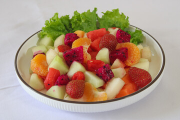 Refreshing Mixed Tropical Fruit Salad Bowl on White