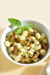 Potato gnocchi with butter, cheese and greens