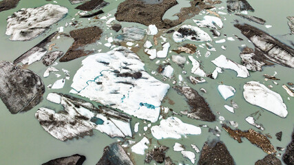 Melting glacier ice and water patterns in Alaska aerial view. Melting glacier ice and water channels forming natural patterns in Alaskan lagoon.