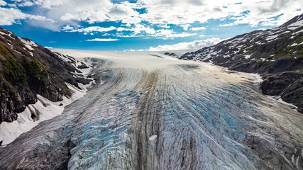 Gardinen Gletscher Aerial view of glacier surface in Alaska. Detailed aerial drone photo of glacier surface textures and ice patterns in Alaskan mountain valley.  © Vadim