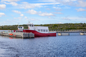 Tour boats at a dock on Western Brook Pond inside Gros Mourne National Park in Newfoundland, room fo text