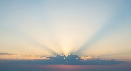 Sun Rays Breaking Through Clouds at Sunrise Over the Horizon