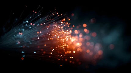 Close up of glowing fiber optic cables with orange and blue lights representing digital connection and data transmission in darkness
