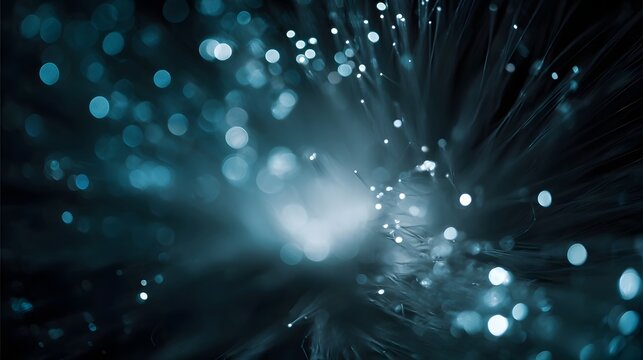 Abstract close up of glowing blue fiber optic strands with bokeh effect symbolizing data transmission and technology