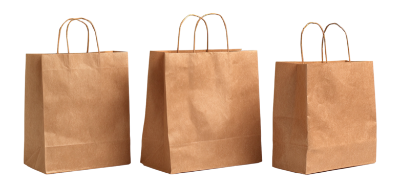 Three brown paper shopping bags standing on a black background. Handles visible