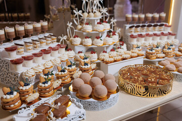 Delicious variety of desserts displayed at a festive event in a beautifully decorated venue