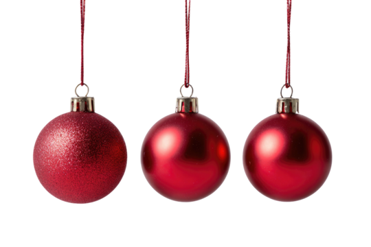 Three vibrant red Christmas baubles, each with a silver cap and hanging ribbon against a black backdrop
