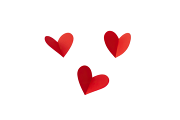 Three red paper hearts with a fold, isolated on a black background, creating a simple design