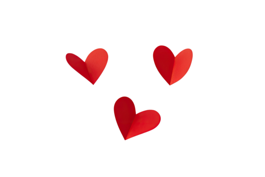 Three red paper hearts with a fold, isolated on a black background, creating a simple design