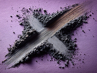 beauty product macro shot showing crumbled dark gray and shimmer pigment dust pattern