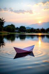 Serene Paper Boat Floating on a Calm Lake at Sunset in Beautiful Landscape