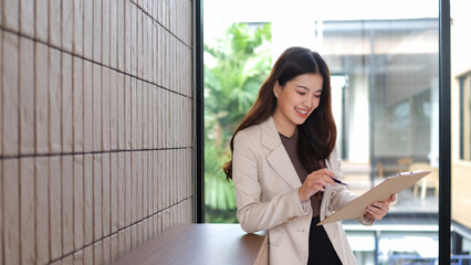 A businesswoman exudes confidence and is holding a blindfold.