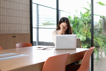 Businesswoman is tired from work