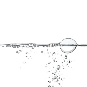 Close-up of water with bubbles, a line of bubbles at the surface, on a black background