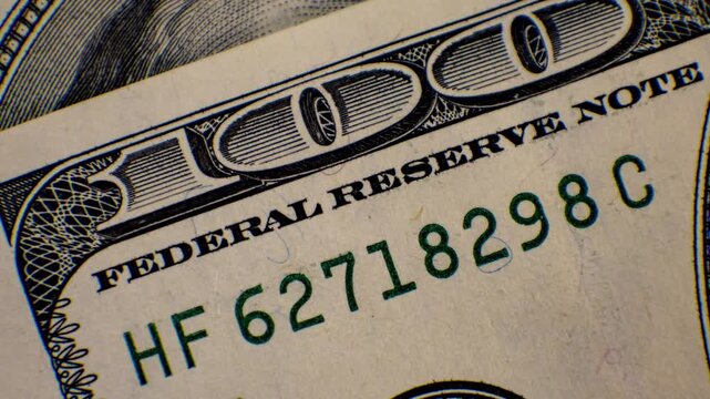 Explore the intricate details of a one hundred dollar bill showcasing its unique features and craftsmanship in vivid close-up imagery