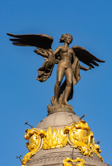Angel on top of Metropolis building on Gran Via street, Madrid, Spain