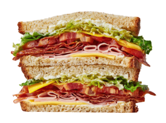 A delicious, layered sandwich on wheat bread, stacked with various meats, cheese, and fresh vegetables