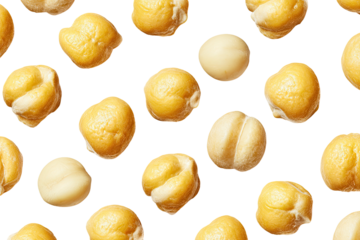 Isolated cooked, golden-yellow chickpeas of varied shapes and textures, scattered against a black backdrop