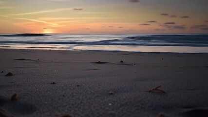 Tranquil Ocean Waves Gently Rolling onto a Sandy Beach During a Vibrant Sunset with Soft Golden and Orange Hues Painting the Horizon and Reflecting