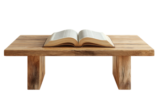 An open book rests on a rough-hewn wooden table with a black background